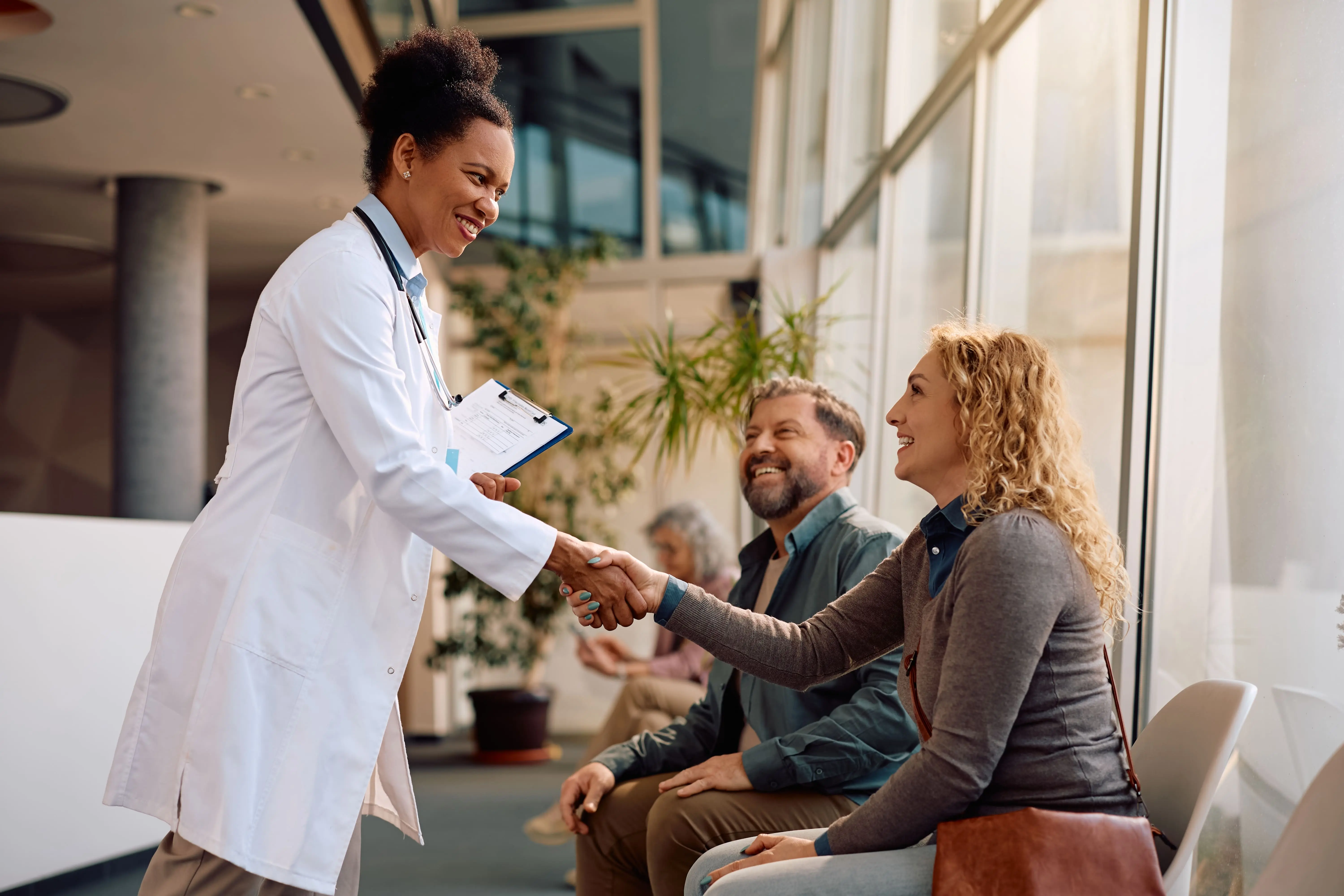 Physician consulting with patients about addiction treatment options in professional outpatient setting