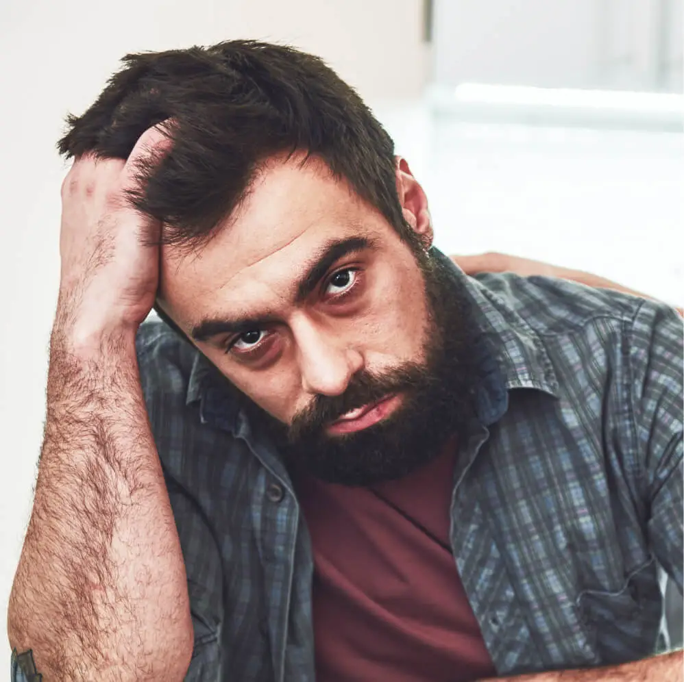 Man with hand on head
