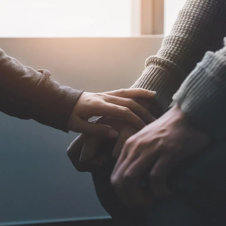 Person with hand on another.