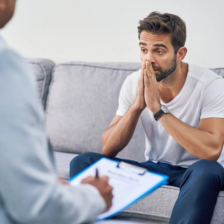 Guy siting on couch talking with an expert