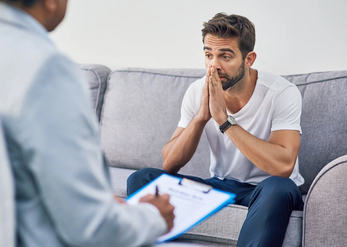 Guy siting on couch talking with an expert